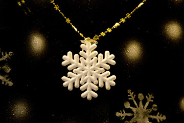 Christmas decorations. White snowflake on a black background.