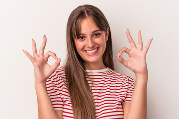 Young caucasian woman isolated on white background cheerful and confident showing ok gesture.