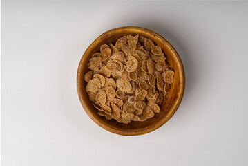 A bowl with corn flakes breakfast on a white background.