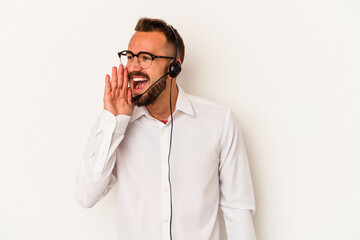 Young caucasian telemarketer man with tattoos isolated on white background  shouting and holding palm near opened mouth.