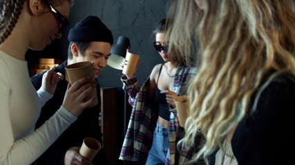 Teen models do a dance to new cool music standing in circle 