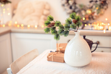 .vase with a branch of a Christmas tree and gifts the theme of the new year and christmas in a homely atmosphere - Image