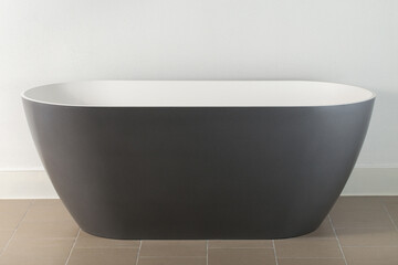 Minimalistic photo with black outside and white inside luxury artificial stone oval bathtub