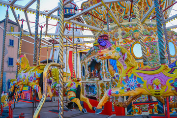 UK, Brigton, 01.10.2021: A carousel from Brighton Pier. The characters are horses and roosters, the back wall is also decorated and has mirrored inserts.