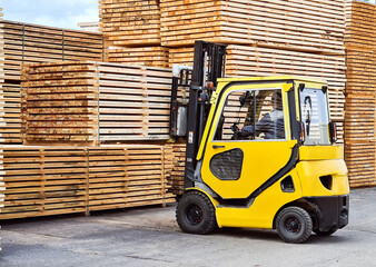 Forklift loads lumber into stacks at the finished product warehouse