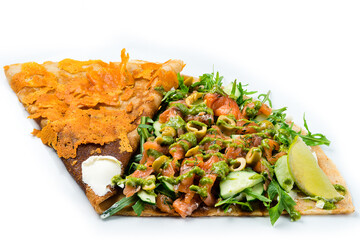 pancake with salmon and olives on a white background