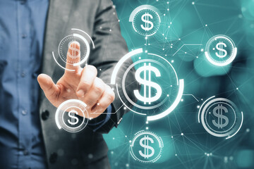 Close up of businessman hand pointing at glowing digital american dollar interface hologram on blurry bokeh background. Online banking, finance, business and investment concept.