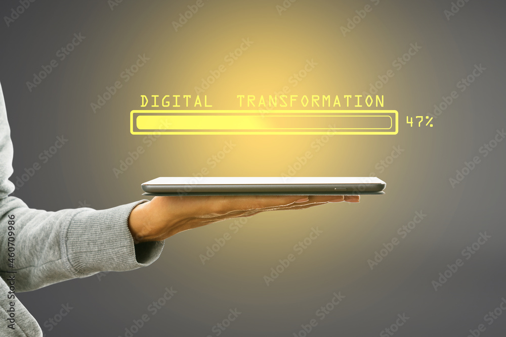 Poster hand holding tablet with abstract glowing loading bar on gray wall background. digital transformatio