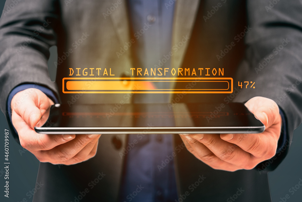 Aufkleber businessman hand holding tablet computer with abstract glowing loading bar on gray wall background. 