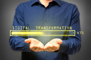 Male hands holding abstract glowing loading bar on gray wall background. Digital transformation, internet, progress and technology concept.