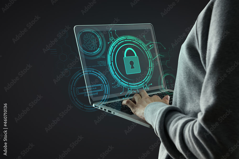 Poster hacker hand using laptop with creative glowing blue digital padlock interface on dark background. on