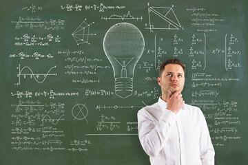 Attractive thoughtful young european businessman with abstract lamp sketch with mathematical...
