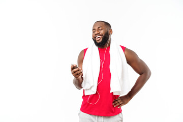 Handsome African American man listening music on his mobile device after sport exercise.