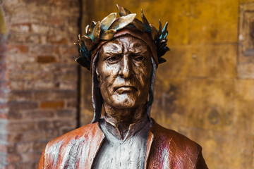 Fototapeta na wymiar Verona, Italy - September 22, 2021: Bronze statue of.Dante Alighieri, author of the Divine Comedy.