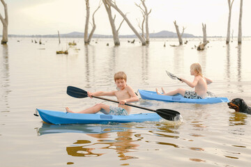 Children kayaking in Summer at Kow Swamp, Victoria Australia