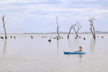 Children kayaking in Summer at Kow Swamp, Victoria Australia