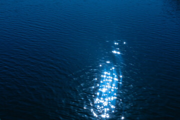 Sunlight relflecting on water in blue
