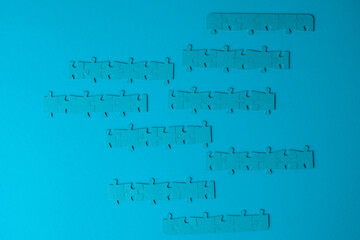 Block chains, a metaphor of the blockchain illustrated with chains of assembled puzzles. Several mosaic elements in a line, on a blue background