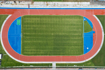 Aerial view of empty new soccer field from above with running tracks around it Amazing new small stadium for many sport disciplines at phuket thailand