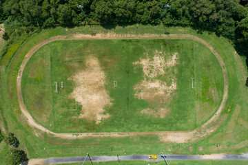 Aerial view of empty green football field with running track Empty stadium view from top