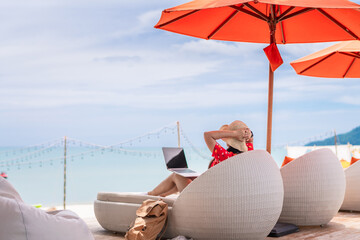 Summer lifestyle traveler woman relax on beach chair in front of vacation exotic beach, Attraction...