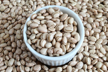 Pinto beans. Closeup of Brazilian beans in a white bowl on a background of carioca beans. Brazilian food.