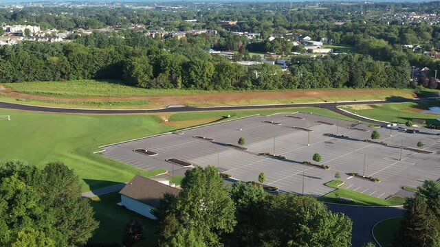 High aerial pan of housing neighborhood and farmland consumed for construction.
