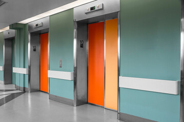 orange elevator door on contrasting walls
