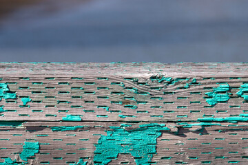 peeling paint on distressed wood railing