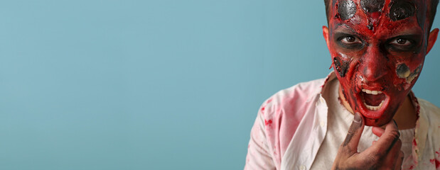 Scary zombie man on color background with space for text