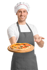Handsome chef showing delicious pizza on white background