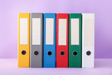Office folders on color background