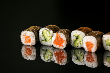 Set of different maki rolls on dark background, closeup © Pixel-Shot