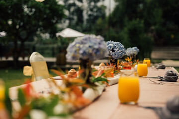table decoration,with orange juice. selective focus and shallow depth of field. horisontal version of the photo.