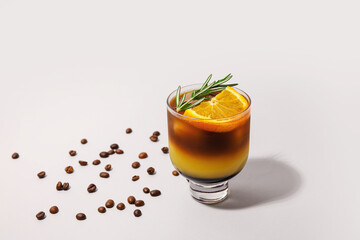Glass of tasty coffee with orange juice on light background