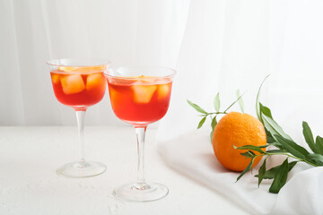 Glasses of Aperol spritz cocktail on light background