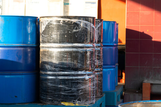 Stack of lube oil or chemical drum barrels which are stored at chemical storage area. Indsutrial equipment object photo.