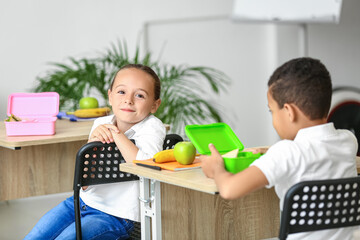 Cute little children having lunch at school