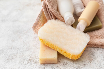 Cosmetic products, soap and sponge on table