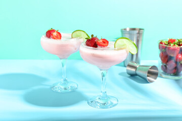 Glasses of strawberry Pina Colada cocktail on color background