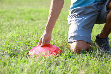 Young man playing frisbee in park, closeup