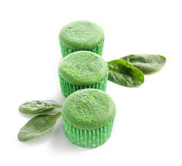 Tasty spinach muffins on white background