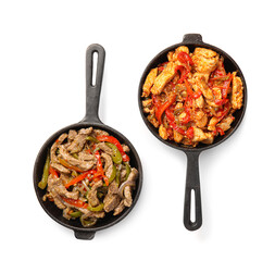 Frying pans with delicious Fajita and vegetables on white background