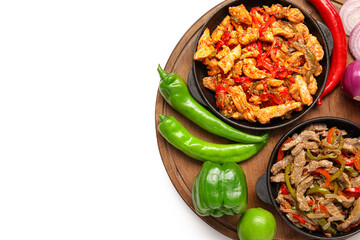 Frying pans with tasty Fajita and vegetables on white background