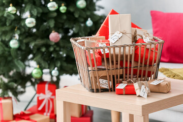 Christmas advent calendar with gift boxes in basket on wooden table