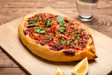 Board with delicious Turkish Pide Pizza on table