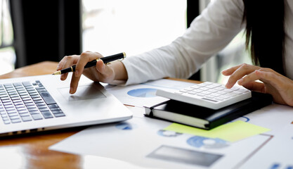 Close up of hand,Financial Businesswomen analyze the graph of the company's performance to create profits and growth, Market research reports and income statistics, Financial and Accounting concept.