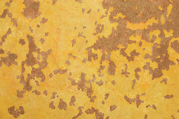 Aged orange brown peeling paint and scratch on faded concrete surface. An erosion and passion of...