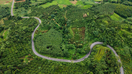 Aerial drone shot Landscape Panorama view, Winding curved road in the middle of the forest at Nan Province, Northern Thailand.