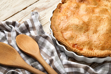 Baking dish with tasty chicken pot pie on white wooden background, closeup